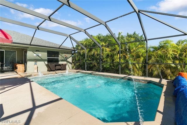 view of pool with pool water feature, a lanai, and a patio area