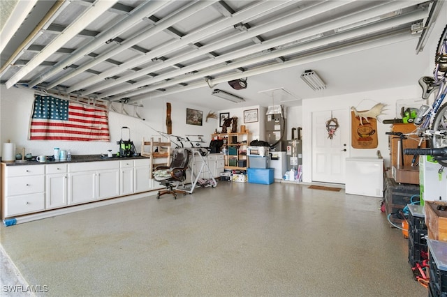 garage featuring a garage door opener and water heater