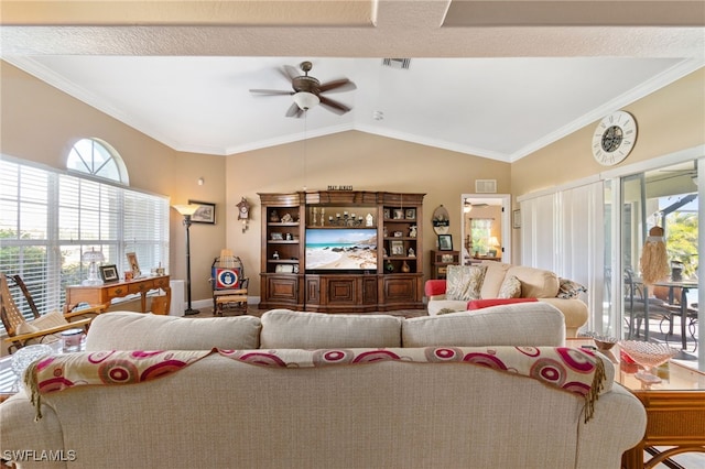 living room with ceiling fan, plenty of natural light, crown molding, and vaulted ceiling