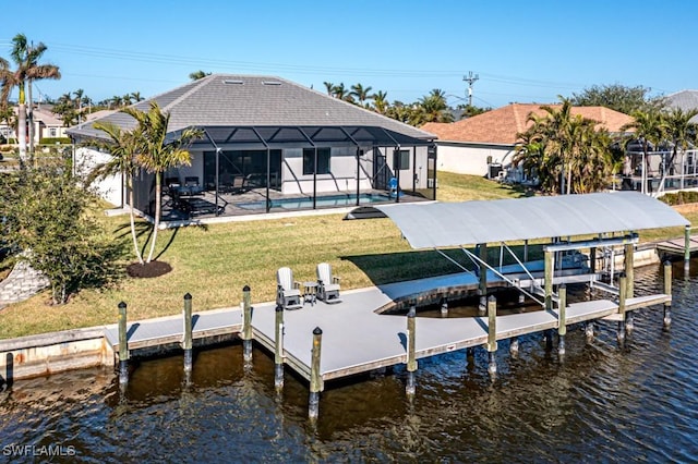 dock area with a lanai, a yard, and a water view