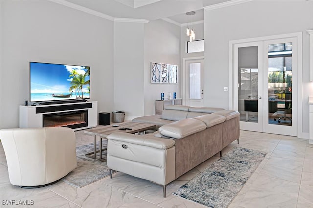 living room with ornamental molding, a high ceiling, and french doors