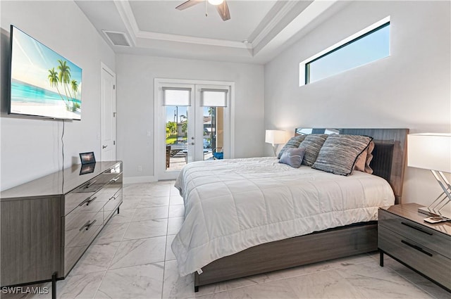 bedroom featuring access to exterior, multiple windows, a raised ceiling, and ceiling fan