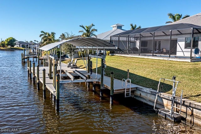 view of dock with a yard, a water view, and glass enclosure