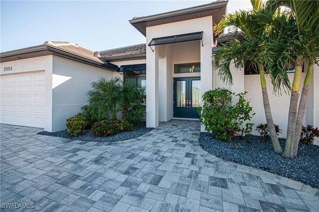 entrance to property with french doors and a garage