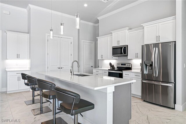 kitchen featuring a center island with sink, white cabinets, stainless steel appliances, and sink