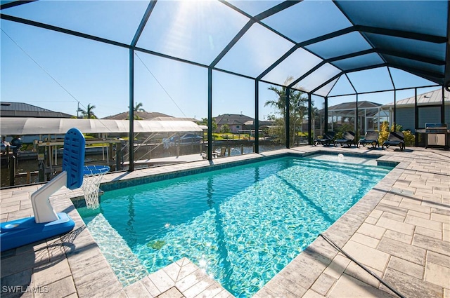 view of pool featuring area for grilling, pool water feature, glass enclosure, and a patio area