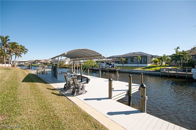 view of dock featuring a lawn and a water view