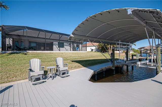 dock area with a lawn, glass enclosure, and a water view