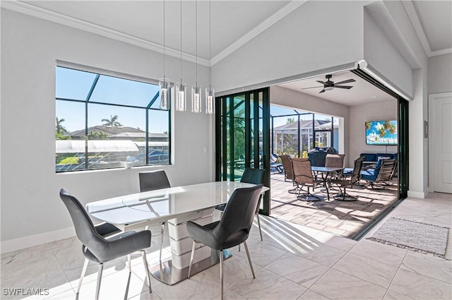 dining space with lofted ceiling, ceiling fan, and ornamental molding