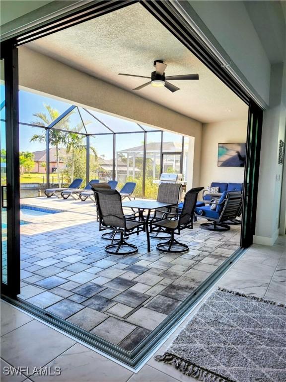 interior space featuring glass enclosure and ceiling fan