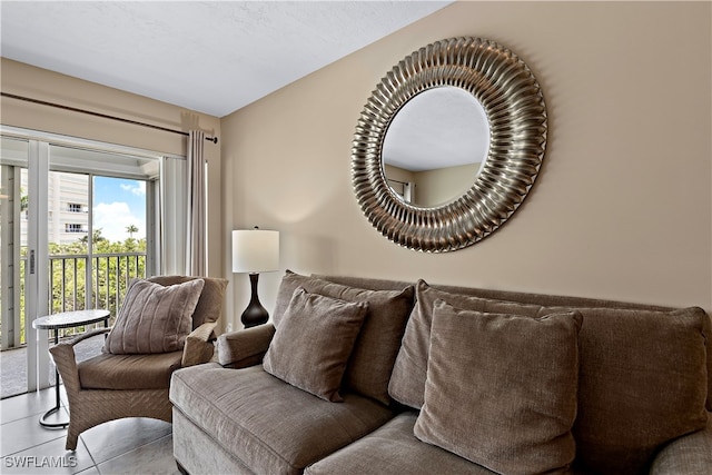 tiled living room featuring a textured ceiling