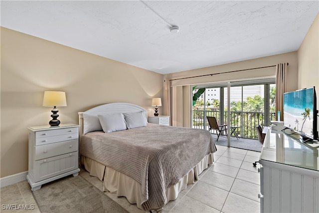 bedroom featuring light tile patterned floors and access to outside