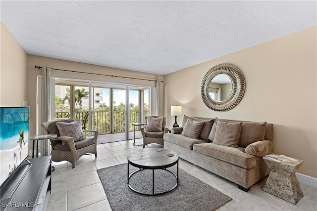 living room with light tile patterned floors and a textured ceiling