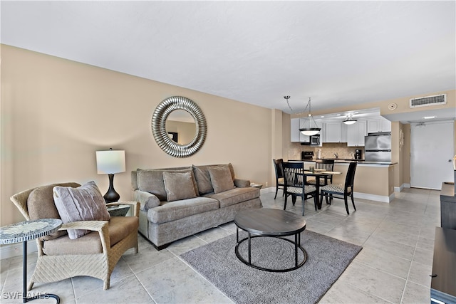 1 Bluebill Ave Unit 409, Naples, FL 34108 - living room with baseboards and light tile patterned floors