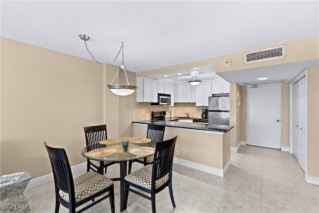 1 Bluebill Ave Unit 409, Naples, FL 34108 - dining area with baseboards