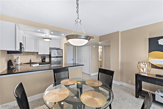 1 Bluebill Ave Unit 409, Naples, FL 34108 - dining room featuring baseboards and recessed lighting