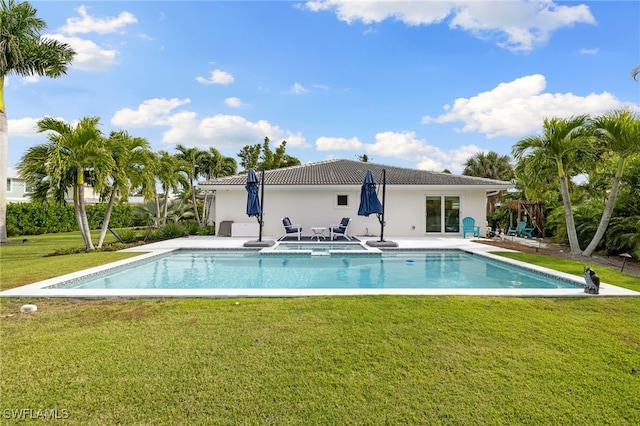 view of swimming pool with a yard and a patio area