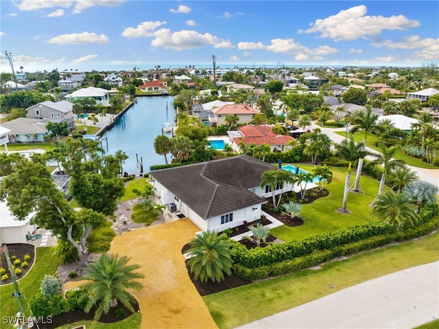 drone / aerial view featuring a residential view and a water view