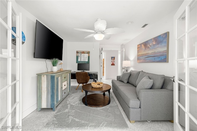 carpeted living room featuring french doors and ceiling fan