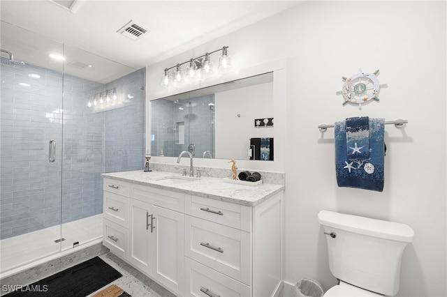 bathroom featuring vanity, toilet, and an enclosed shower