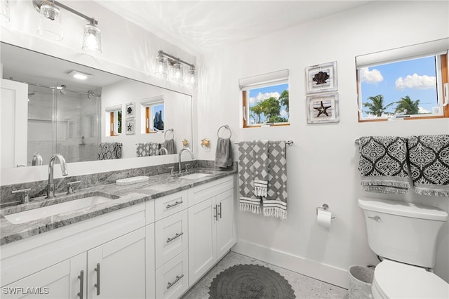 bathroom featuring toilet, vanity, and walk in shower