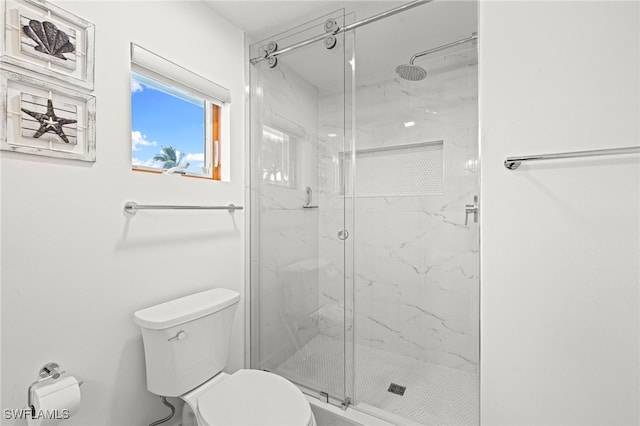 bathroom featuring toilet and walk in shower