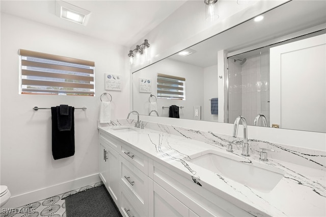 bathroom with toilet, vanity, and tile patterned floors