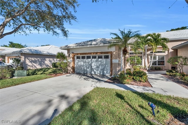 single story home featuring a garage and a front lawn