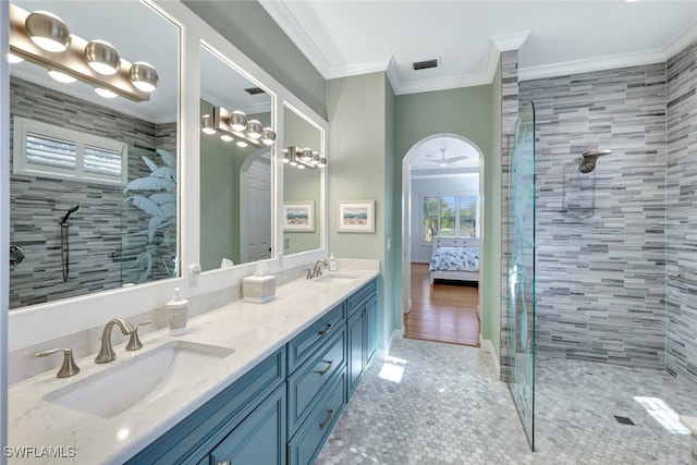 bathroom featuring vanity, ceiling fan, crown molding, tiled shower, and hardwood / wood-style floors