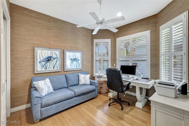 home office with ceiling fan and light wood-type flooring