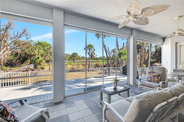 sunroom / solarium featuring ceiling fan