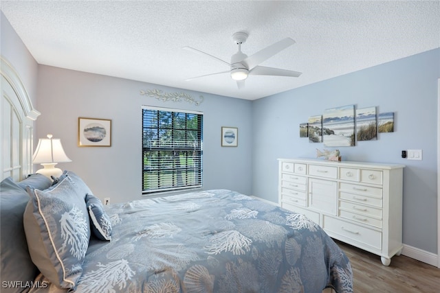 bedroom featuring a textured ceiling, ceiling fan, and dark hardwood / wood-style floors