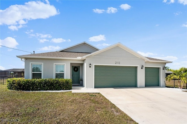 view of front of property with a garage and a front lawn