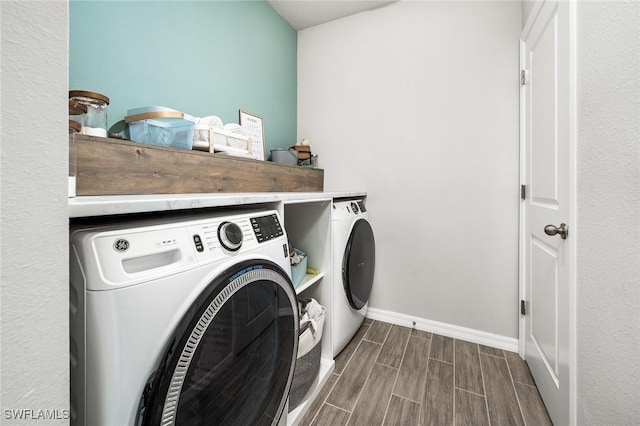 laundry area with washing machine and clothes dryer