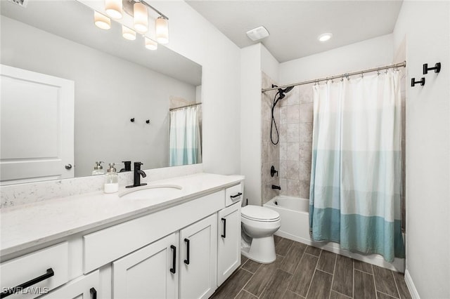 full bathroom with vanity, shower / bath combination with curtain, and toilet