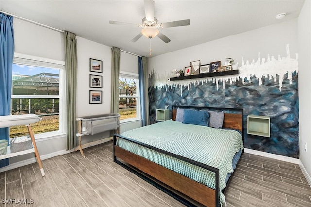 bedroom with wood tiled floor, baseboards, and ceiling fan