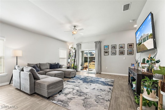 living room with ceiling fan and light hardwood / wood-style flooring