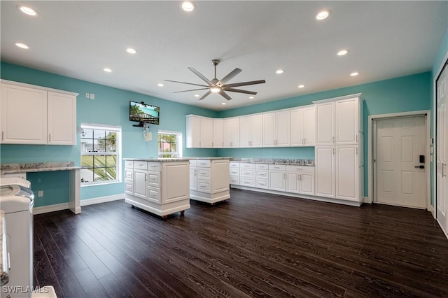 kitchen featuring ceiling fan, dark hardwood / wood-style flooring, white cabinetry, and washer / clothes dryer