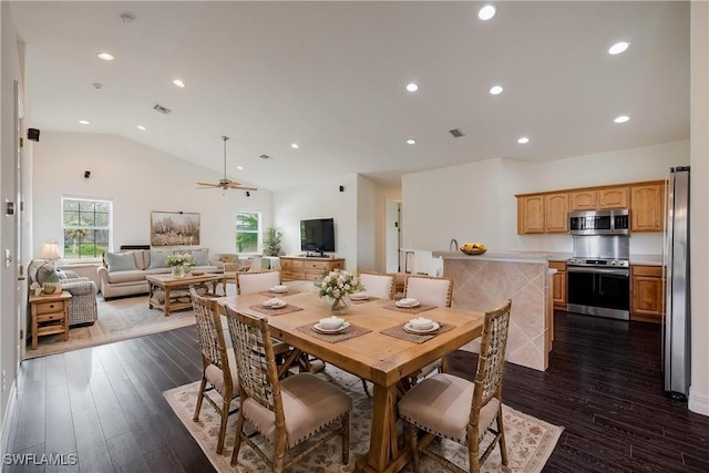 dining space featuring ceiling fan, dark hardwood / wood-style flooring, and vaulted ceiling