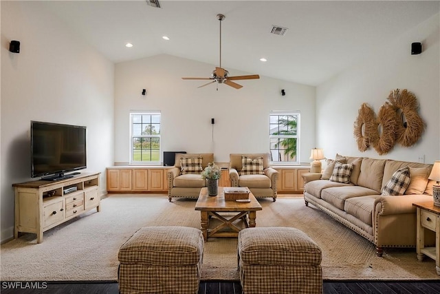 carpeted living room featuring plenty of natural light, ceiling fan, and high vaulted ceiling