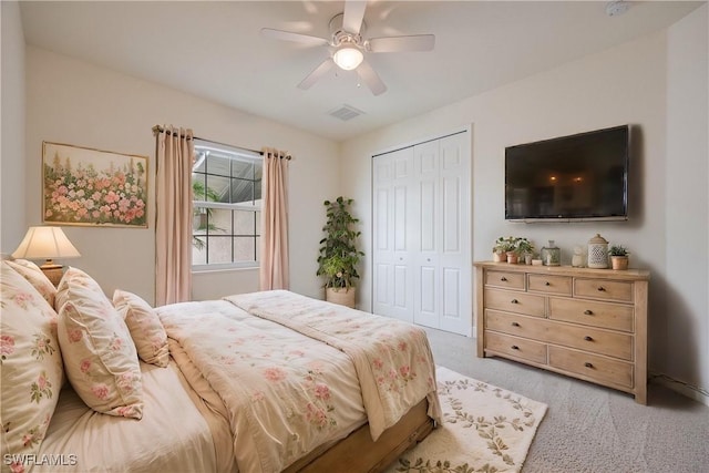 carpeted bedroom featuring a closet and ceiling fan