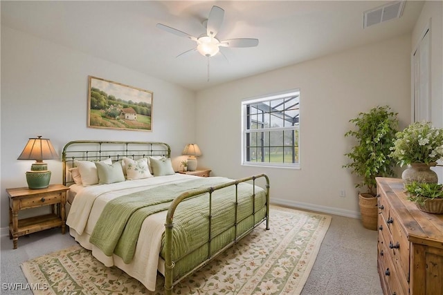 bedroom featuring light carpet and ceiling fan