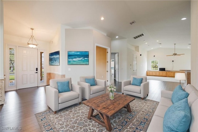 living room featuring wood-type flooring, ceiling fan, and lofted ceiling