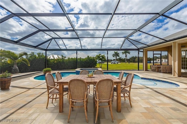 view of swimming pool with glass enclosure and a patio