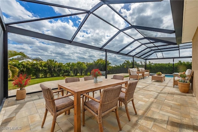 view of patio with an outdoor living space and glass enclosure