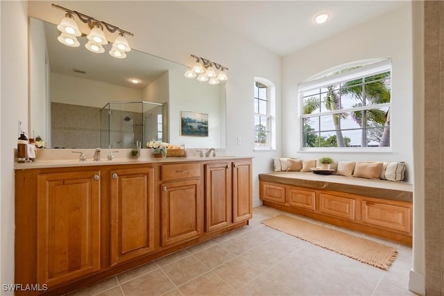 bathroom featuring tile patterned floors, vanity, and a shower with shower door