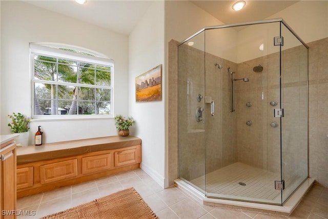 bathroom with tile patterned floors and walk in shower