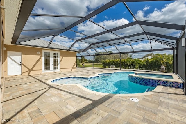 view of pool featuring a lanai, an in ground hot tub, a patio, and french doors