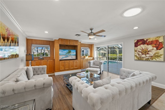 living room with crown molding, ceiling fan, and hardwood / wood-style flooring