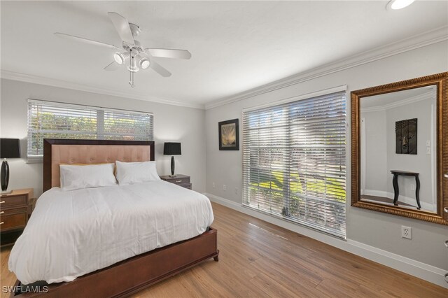 bedroom with crown molding, light wood-type flooring, and ceiling fan